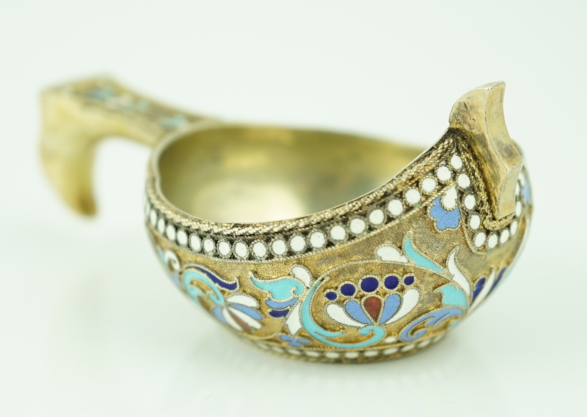 A late 19th/early 20th century Russian 84 zolotnik silver gilt and polychrome enamelled kovsh